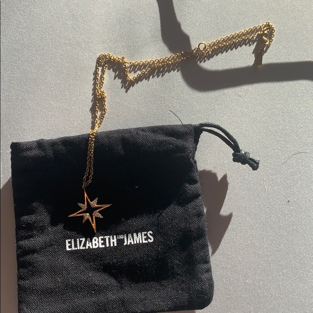 Gold Elizabeth AND James necklace.